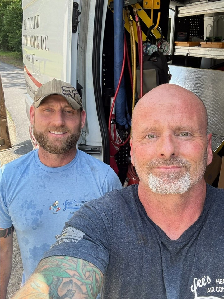 Lee's Heating and Air technician performing furnace repair in a Conyers, GA home